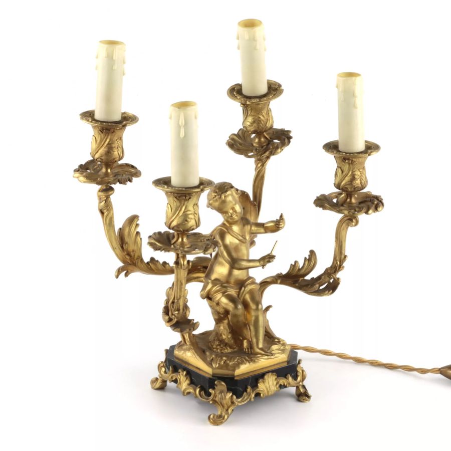 Antique Paired lamps of gilded bronze with cupids playing music.