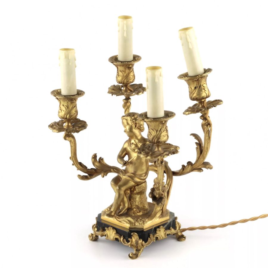 Antique Paired lamps of gilded bronze with cupids playing music.