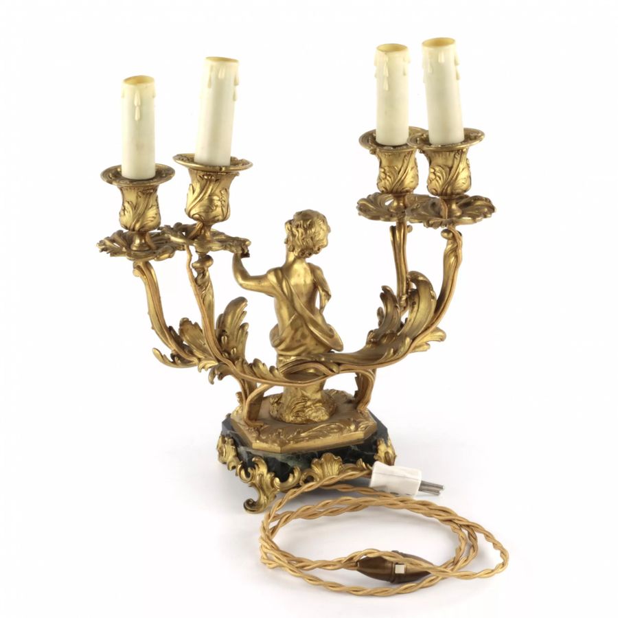 Antique Paired lamps of gilded bronze with cupids playing music.