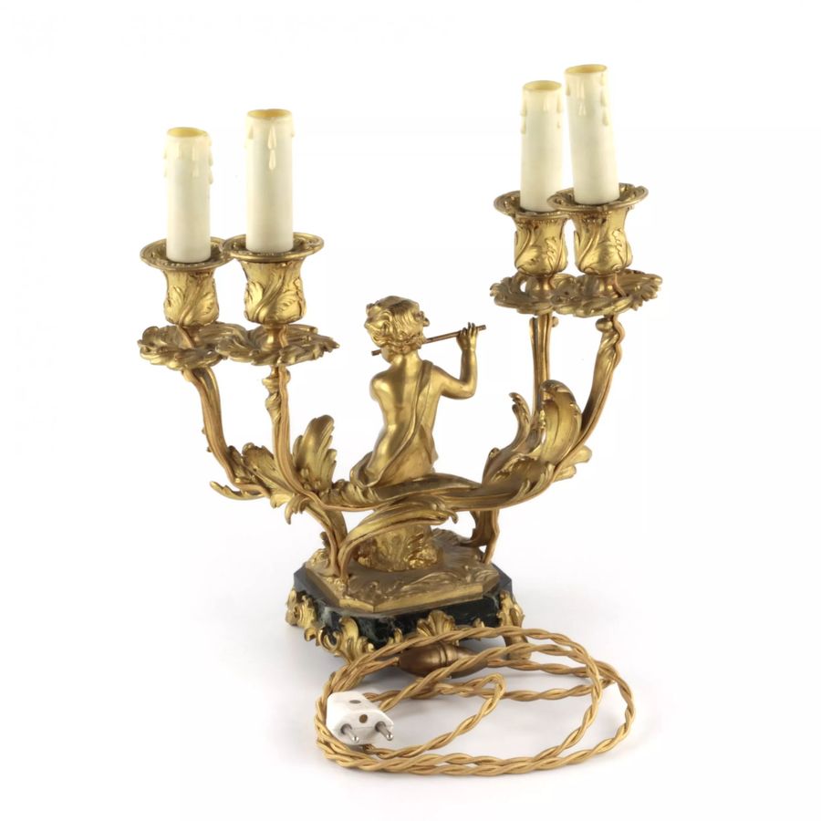 Antique Paired lamps of gilded bronze with cupids playing music.