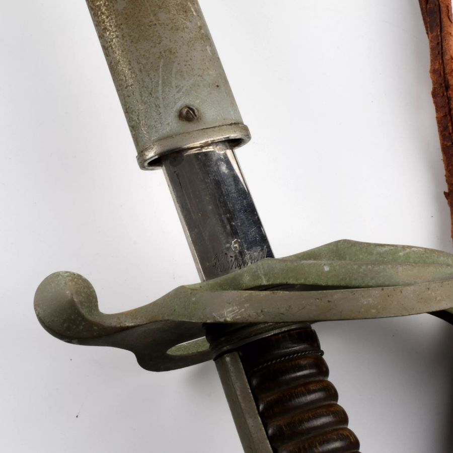 Antique Shaped sword with a steel hilt and scabbard.