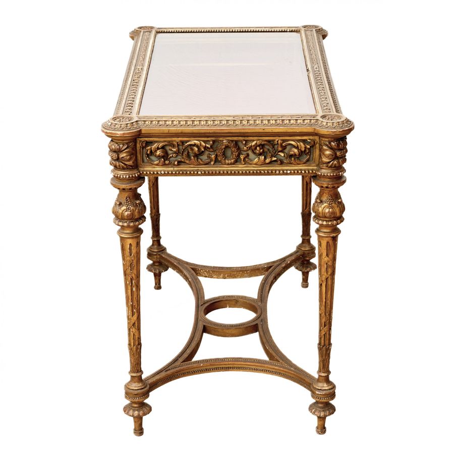 Antique Carved showcase-table of gilded wood, in the spirit of Napoleon III, late 19th century.