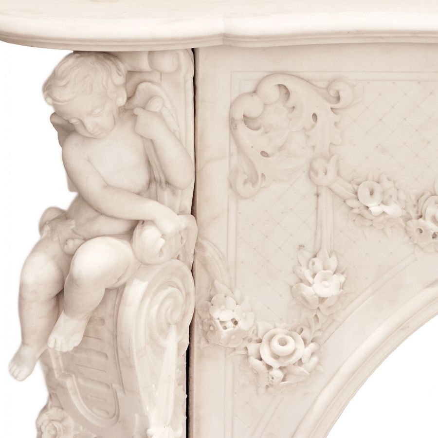 Antique French white marble fireplace with cupids, Louis XV style. 19th century