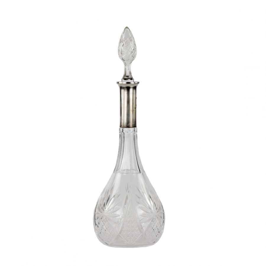 Antique Crystal decanter with a silver neck.