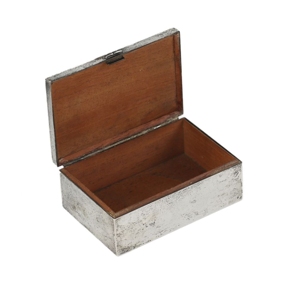 Antique Wooden box upholstered with silver-plated metal. 20th century.