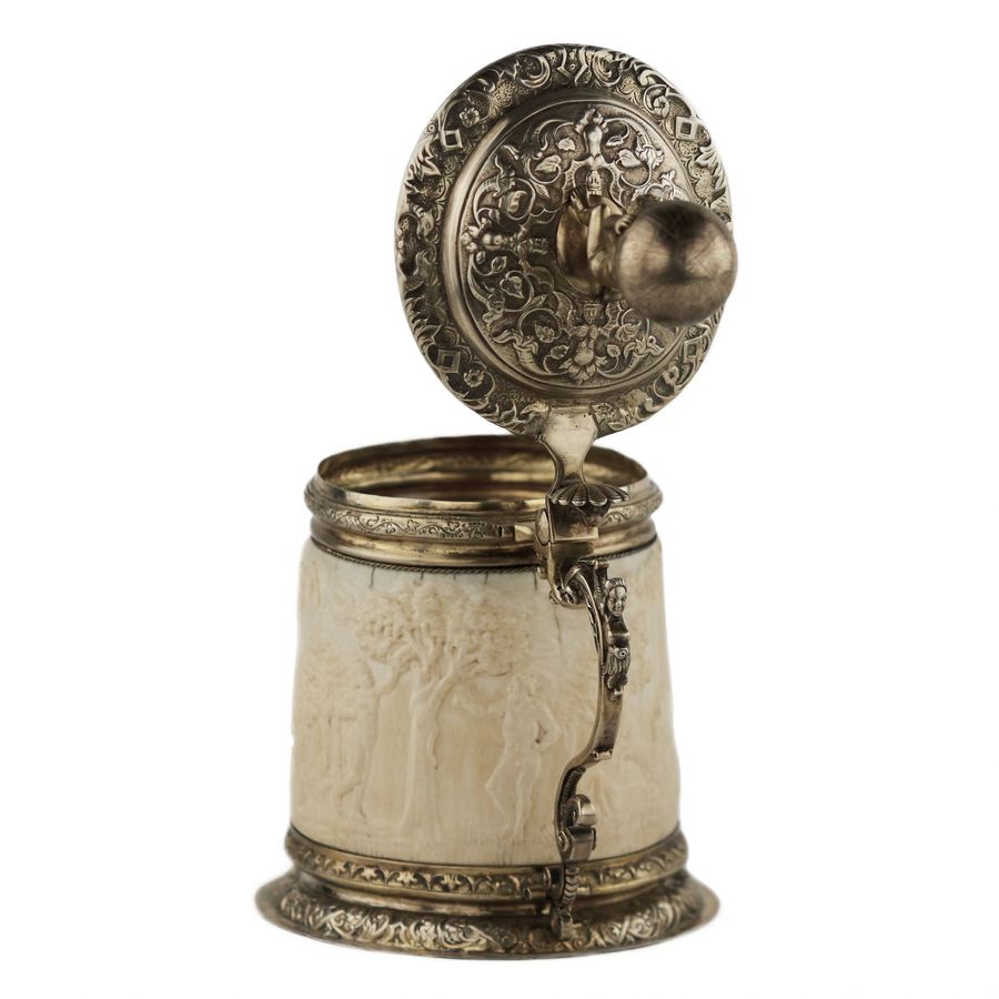 Antique Silver beer goblet with Atlas on the lid and religious scenes on ivory. Lubeck. 17th century.