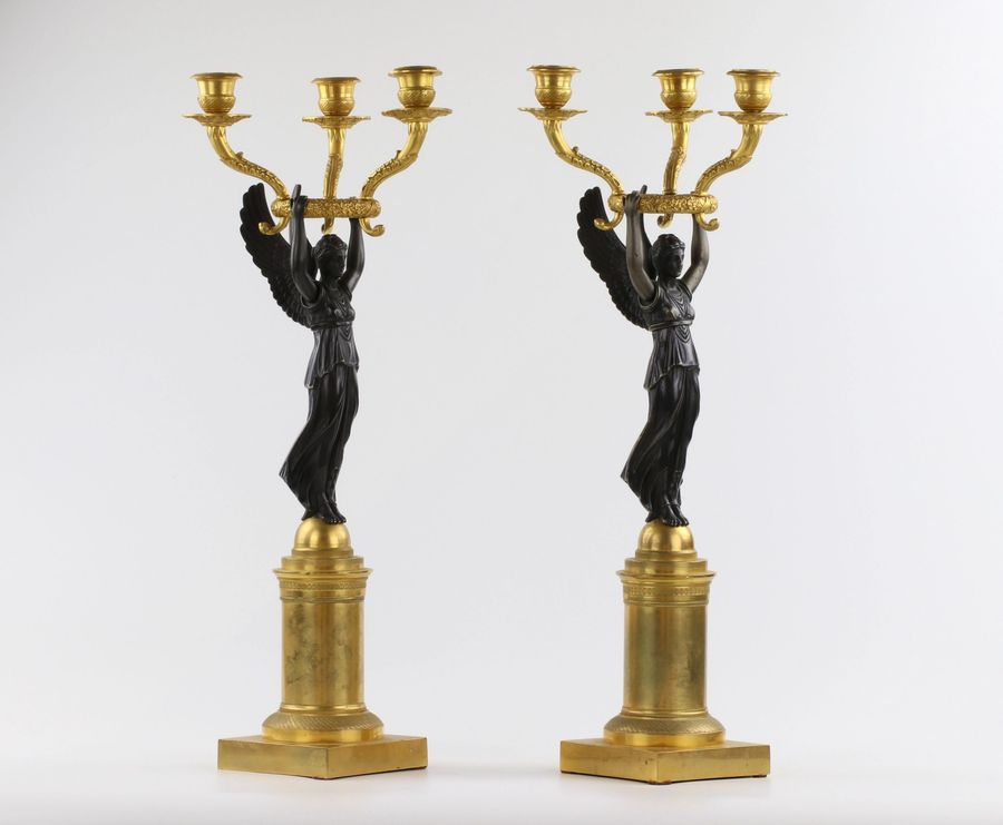 Antique A pair of bronze candlesticks in Empire style