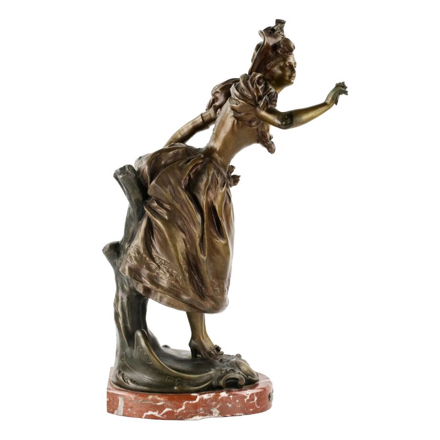 Antique French, bronzed metal figure on a marble base. Happy holiday.