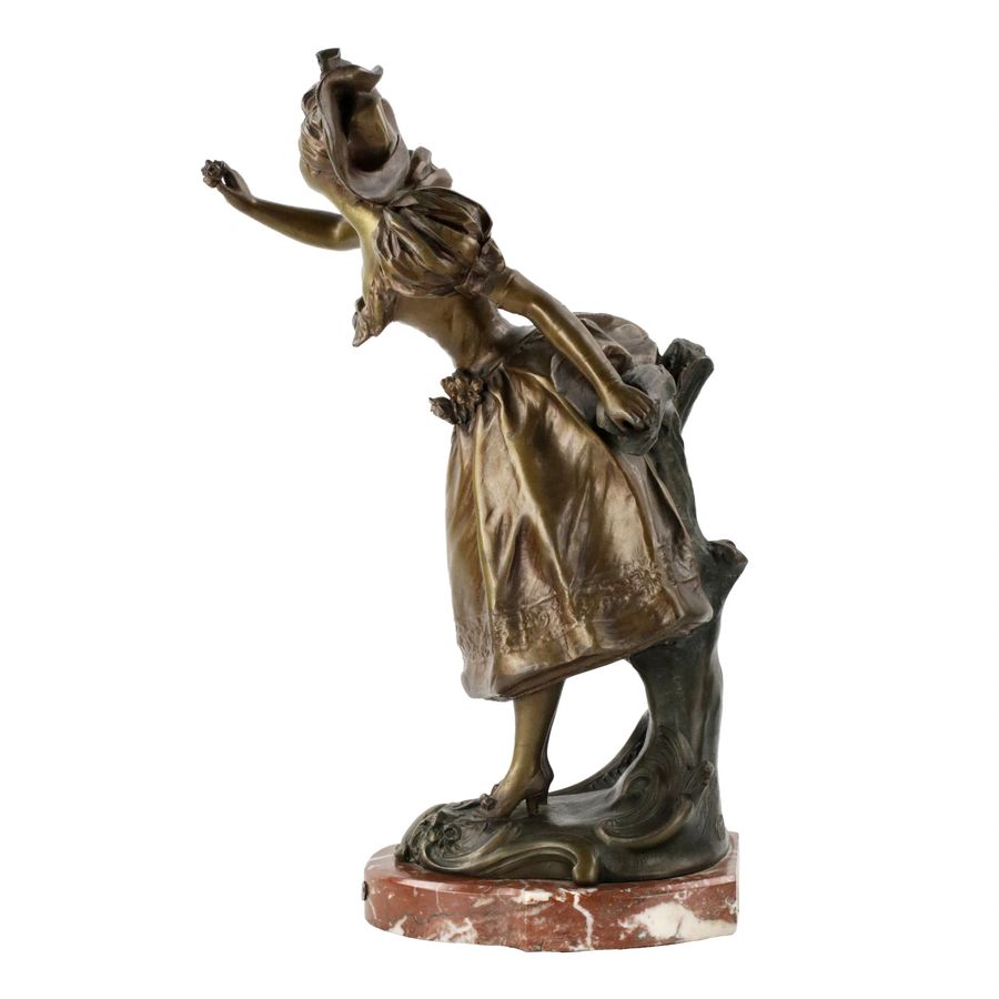 Antique French, bronzed metal figure on a marble base. Happy holiday.