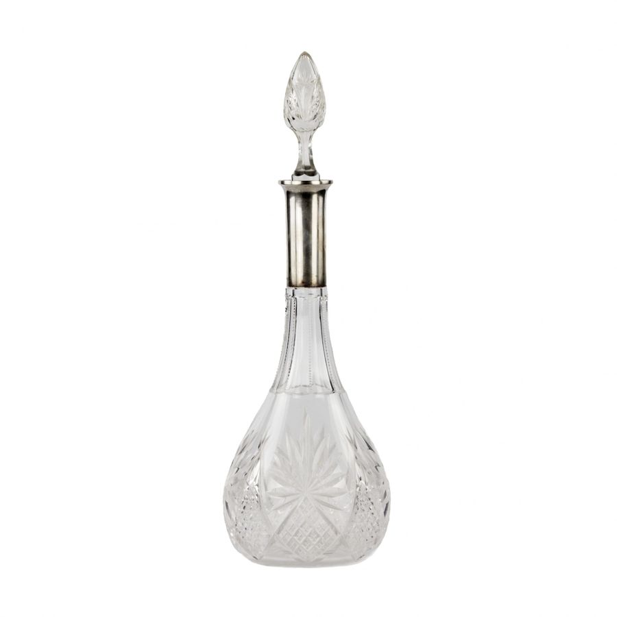 Crystal decanter with a silver neck.