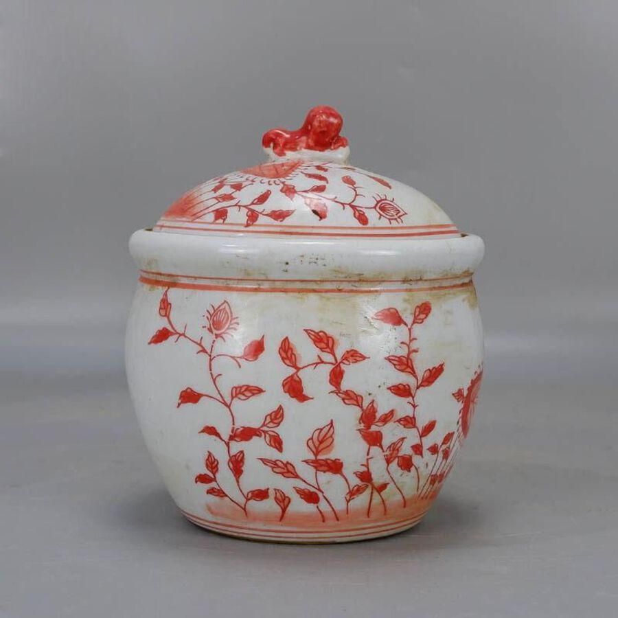 Red-colored oil jar with lid