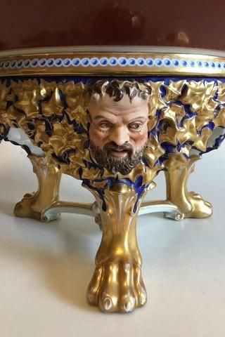 Antique Bing og Grondahl Punch Bowl on stand of porcelain, decorated in red, blue and gold. Stand with modeled leaves, faun and buck heads, standing on three animal paws style of Heinrich Hansen