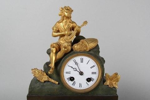 Antique Antique Mental clock with playing man in Bronze and partly gilded