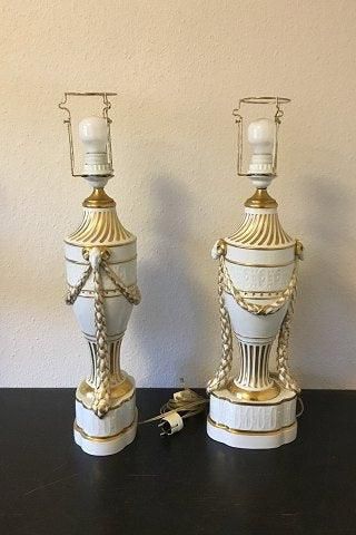 Antique Royal Copenhagen A pair of baluster-shaped lamps on base decorated with garlands, Ram heads and gold. With Juliane Marie Stamp from 1905-12. Mounted with EL bulbs and wire.
