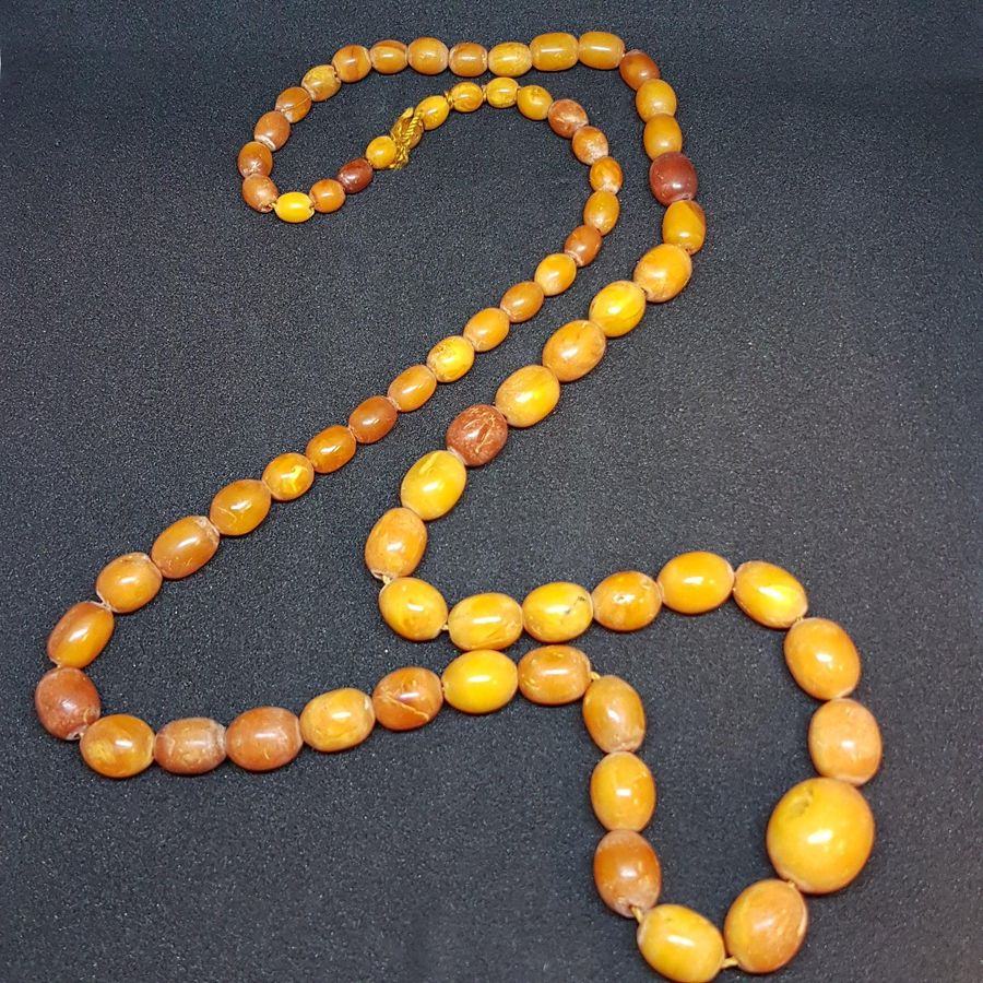 Antique Antique Butterscotch baltic sea amber necklace with olive shaped beads. Length 72 cm