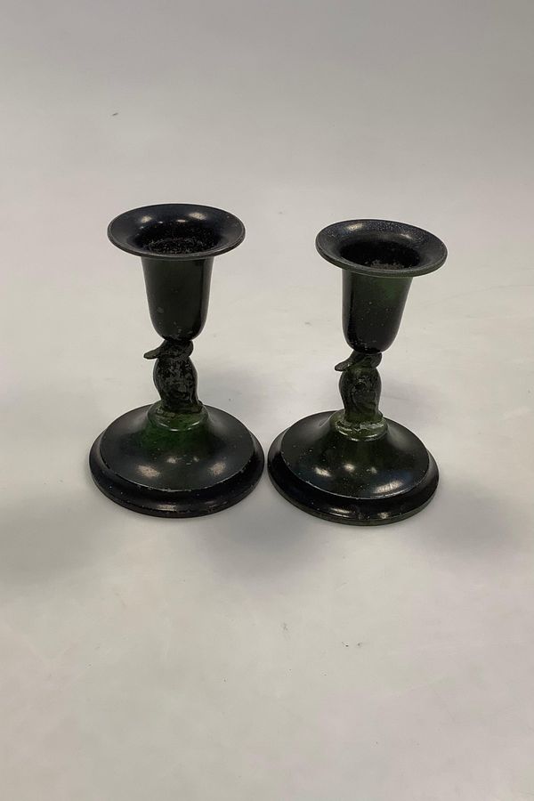 A pair of Danish small bronze candlesticks with ugly motif