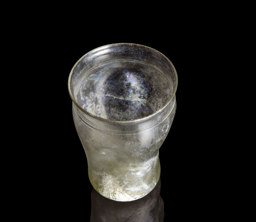 Antique A Roman glass beaker with indented sides