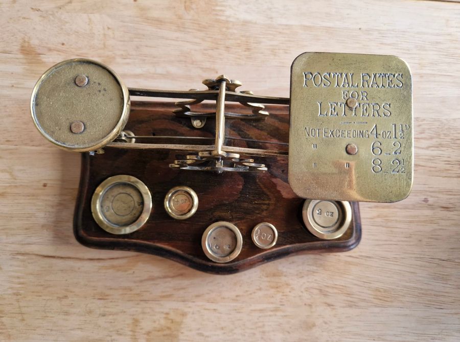 Antique Antique wood and brass postal scale. Includes weights