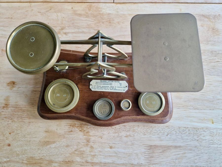 Antique Antique wood and brass postal scale. Includes weights.