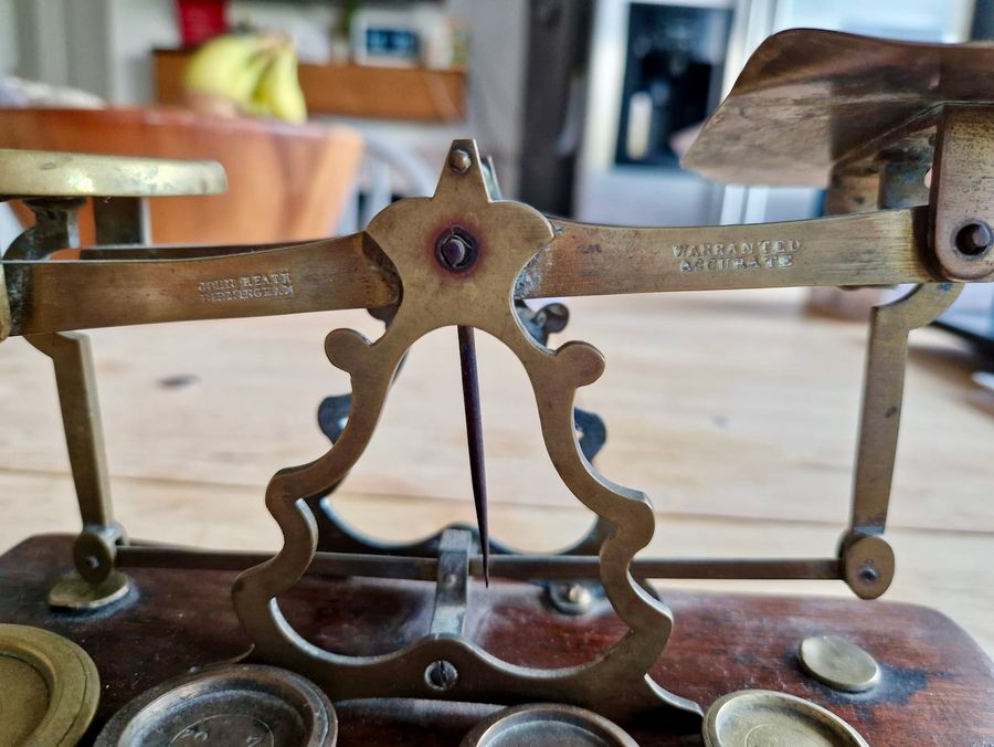 Antique Antique wood and brass postal scale. Includes weights.