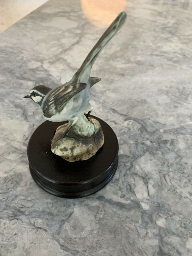 Antique A vintage West Germany kaiser porcelain bird figurine sit on a wooden plinth